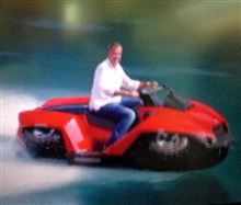An Alfa Romeo 4C races a quad bike jet/ski in Lake Como
